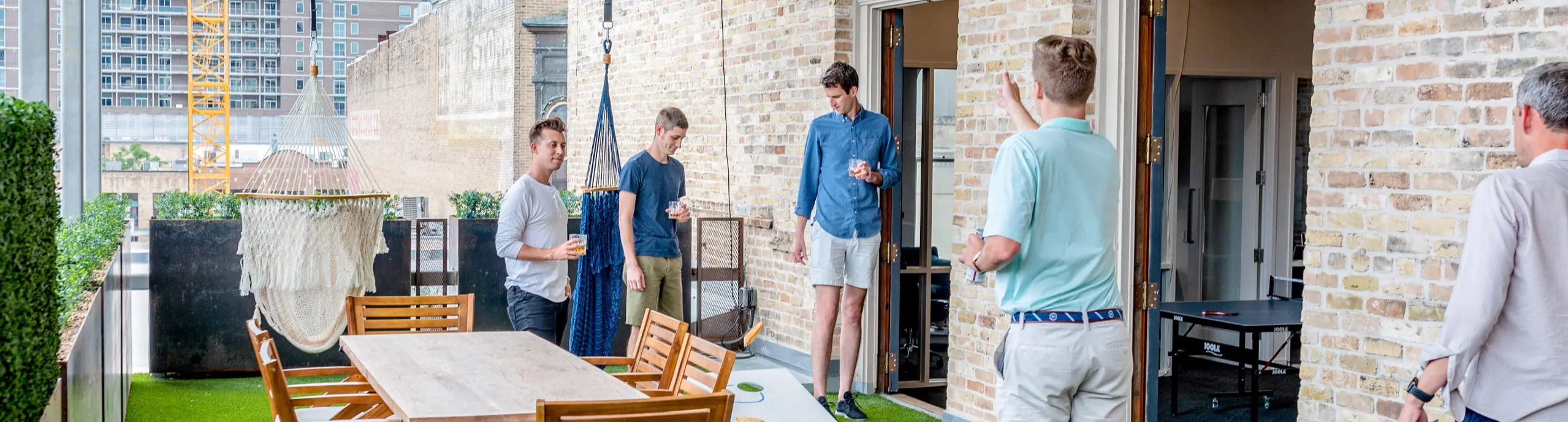 Colleagues talking on the office roof terrace at the end of the day