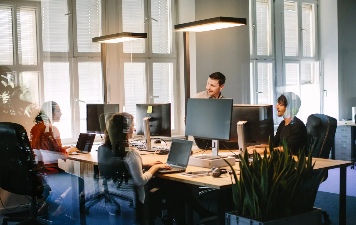 An IT team working together at a shared desk